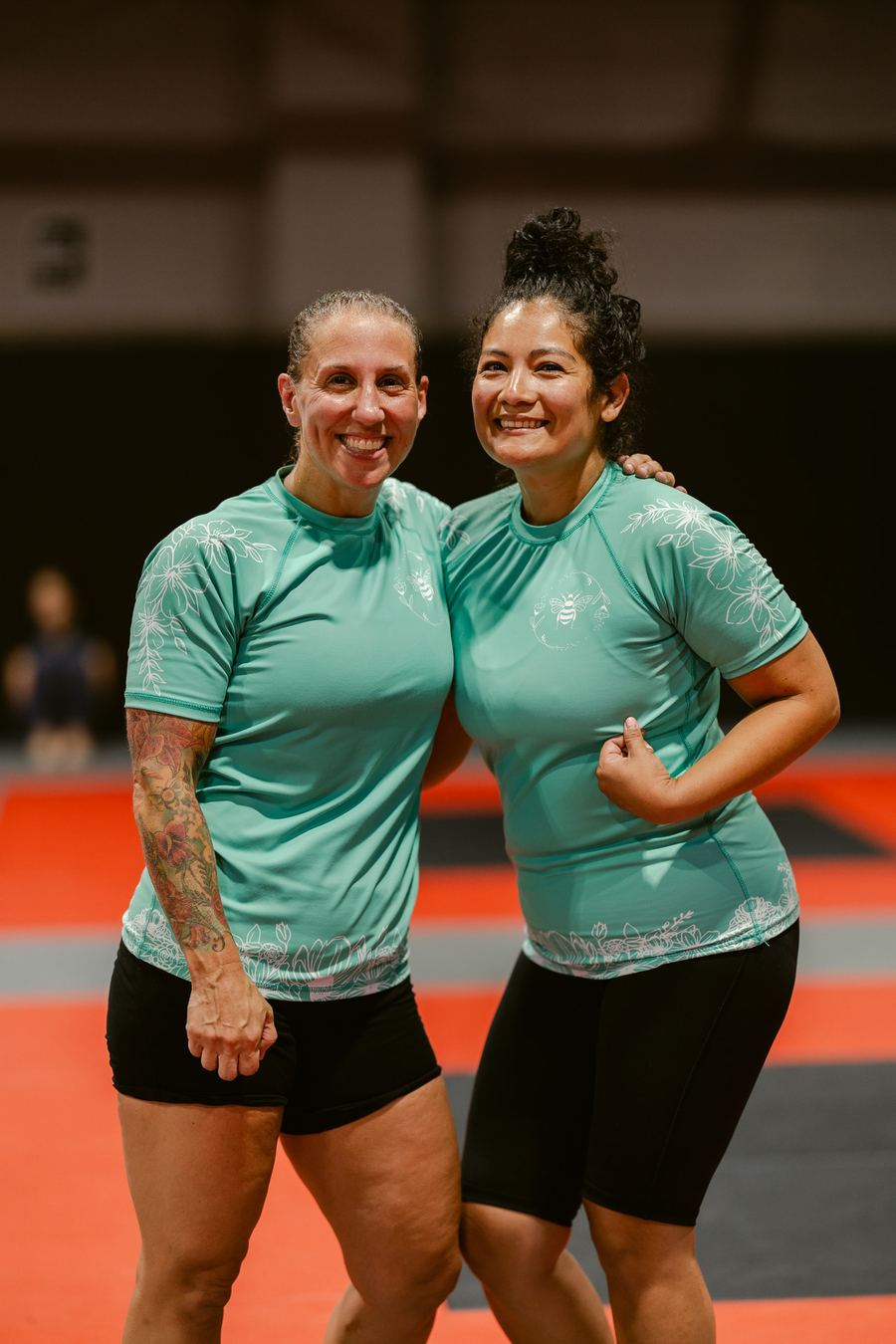 Two training partners in matching mint Slay rashguards